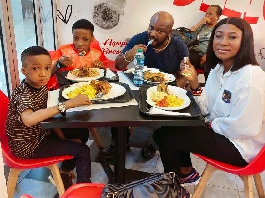 Emeka Ogbonna and his family eating together at a restaurant during a family outing