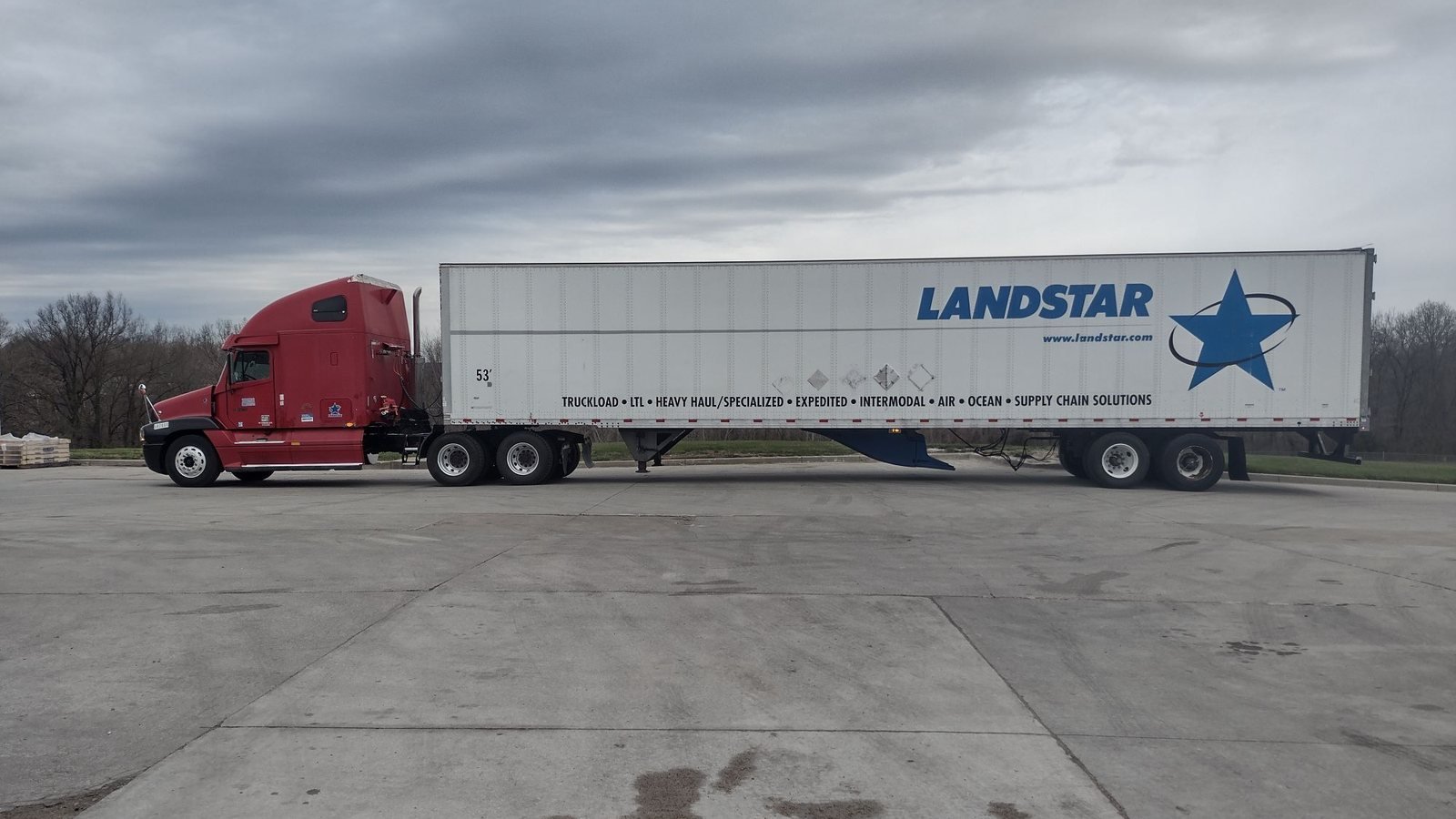 Emeka Ogbonna's red 2009 Freightliner Columbia semi truck hooked to a white Landstar trailer